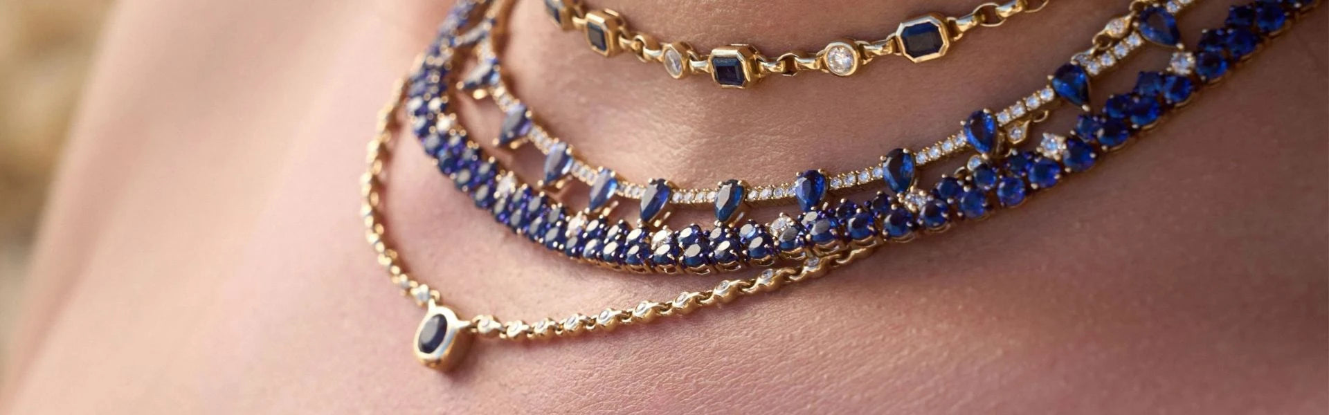 Elyzian vibrant blue sapphire and diamond necklaces layered on neck, handpicked gemstone fine jewelry
