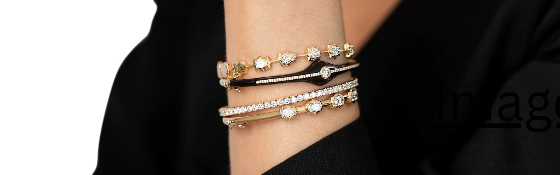 Elyzian diamond tennis bracelets and gold bangles stacked on wrist, luxury fine jewelry arm candy styling