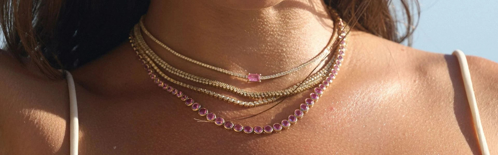 Elyzian pink sapphire and gold layered necklaces golden hour, vibrant gemstone luxury fine jewelry styling