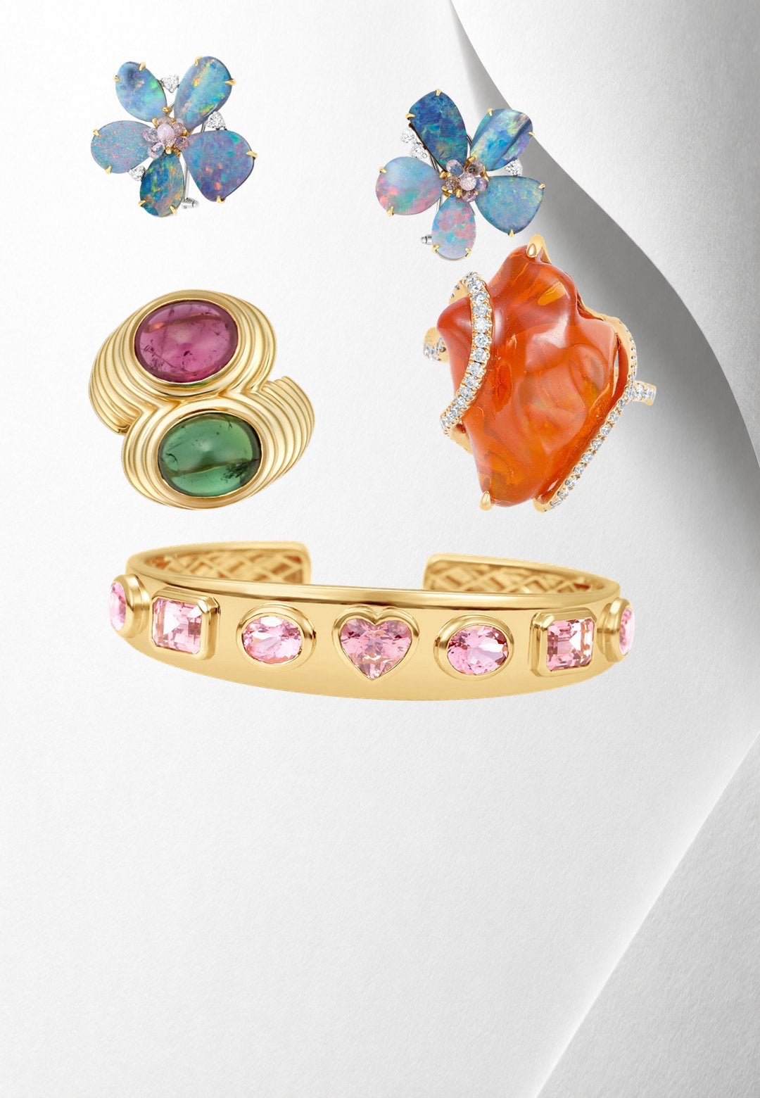 Exquisite 14K yellow gold bangle featuring seven mixed-shape pink tourmalines, including oval, cushion, and heart shapes, blending sophistication with playful charm for a luxurious statement piece. On model.