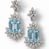 Elyzian emerald-cut aquamarine and diamond drop earrings in 18K white gold, with diamond-set leaf surrounds and floral tops, on a white background.