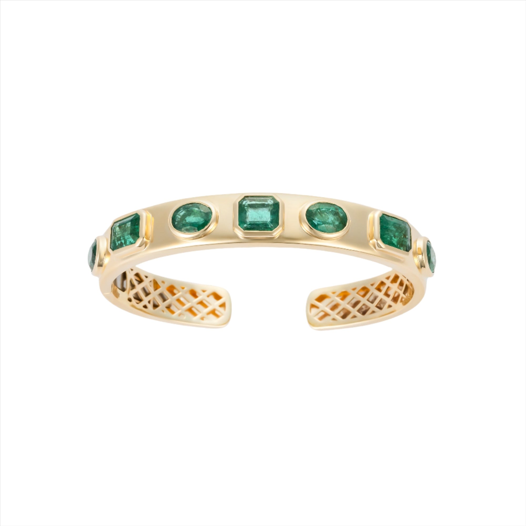 Exquisite 14K yellow gold bangle featuring seven bezel-set emeralds in mixed shapes totaling 10 carats, creating a bold yet refined statement of elegance and color.