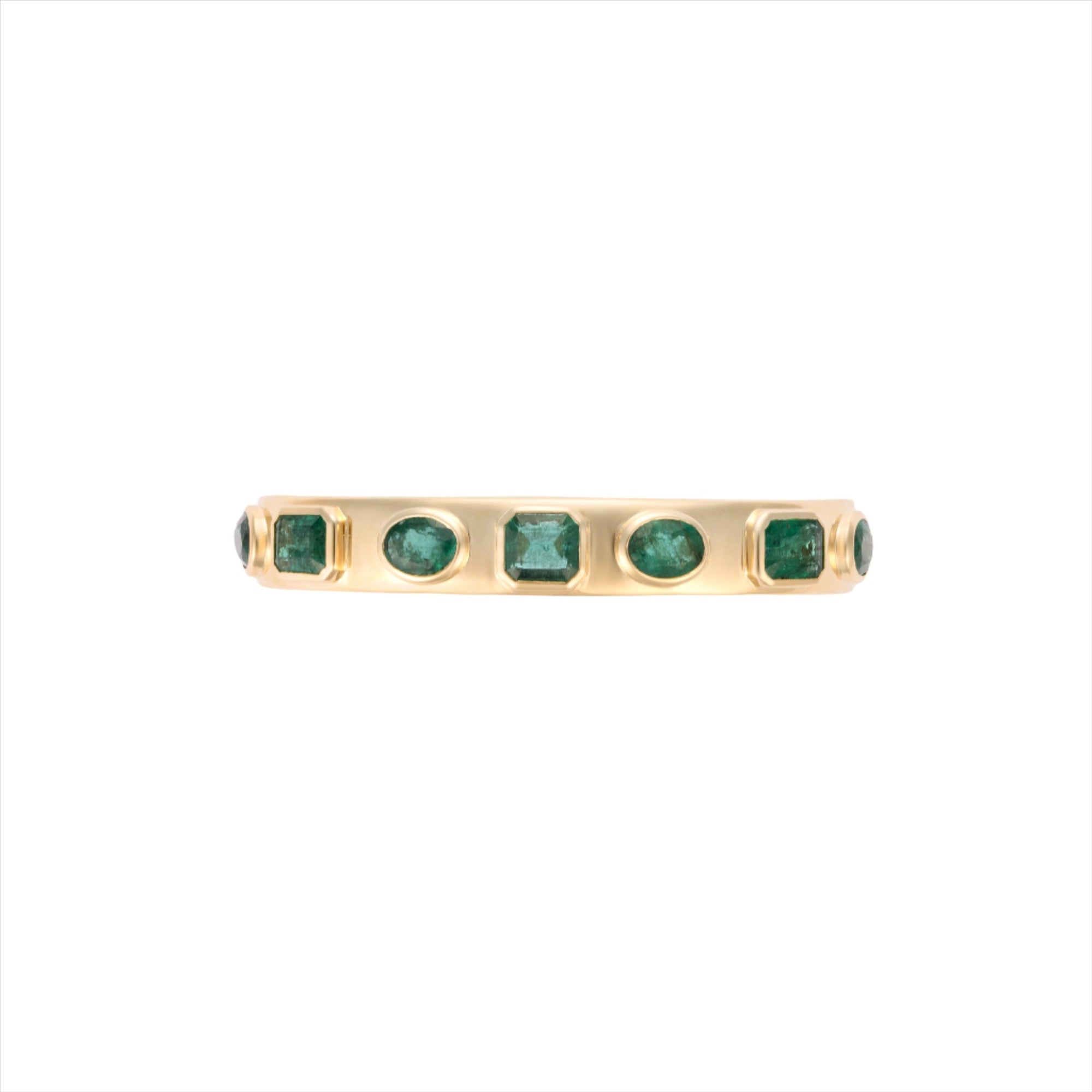 Exquisite 14K yellow gold bangle featuring seven bezel-set emeralds in mixed shapes totaling 10 carats, creating a bold yet refined statement of elegance and color.