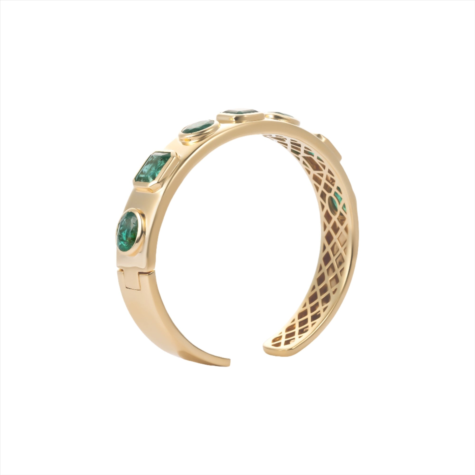 Exquisite 14K yellow gold bangle featuring seven bezel-set emeralds in mixed shapes totaling 10 carats, creating a bold yet refined statement of elegance and color.