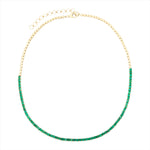 Elegant 14K yellow gold tennis necklace featuring 7.04ct of vibrant emeralds in a classic design, with an adjustable length from 15 to 18 inches for a versatile, refined fit.