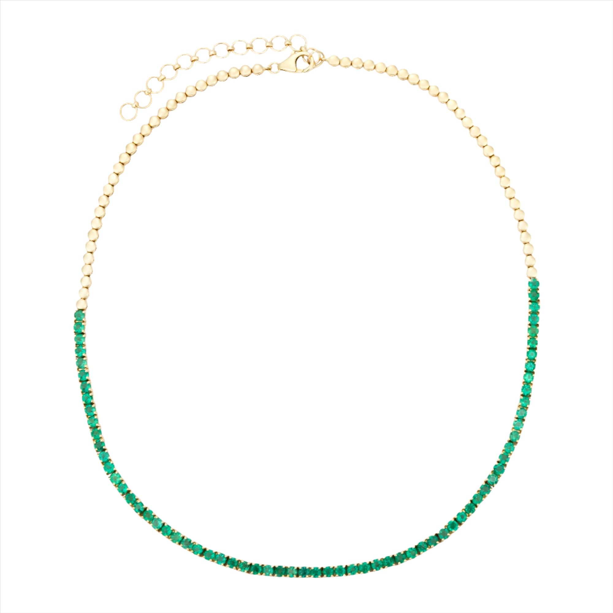 Elegant 14K yellow gold tennis necklace featuring 7.04ct of vibrant emeralds in a classic design, with an adjustable length from 15 to 18 inches for a versatile, refined fit.