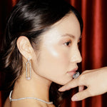 Exquisite 14K white gold cocktail ring featuring a vibrant aquamarine centerpiece framed by sparkling diamond accents, capturing attention with its dazzling design. On model with diamonds, pearls and cocktail ring.