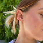 Modern 14K yellow gold huggie earrings featuring a staggered stack design with 26 baguette-cut G-H VS diamonds per hoop (1.16ct total), secured with a lever back closure—perfect for everyday elegance.
