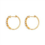 Modern 14K yellow gold huggie earrings featuring a staggered stack design with 26 baguette-cut G-H VS diamonds per hoop (1.16ct total), secured with a lever back closure—perfect for everyday elegance.
