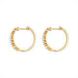 Modern 14K yellow gold huggie earrings featuring a staggered stack design with 26 baguette-cut G-H VS diamonds per hoop (1.16ct total), secured with a lever back closure—perfect for everyday elegance.
