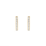 Sleek 14K yellow gold paperclip hoop earrings featuring stacked bezel-set baguette diamonds, blending modern design with understated luxury for everyday elegance.