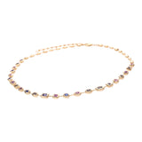 Stunning adjustable 14K yellow gold necklace featuring a unique arrangement of mixed-shaped bezel-set pastel sapphires, adding a light touch of color and elegance to any ensemble. Close up side angle. 