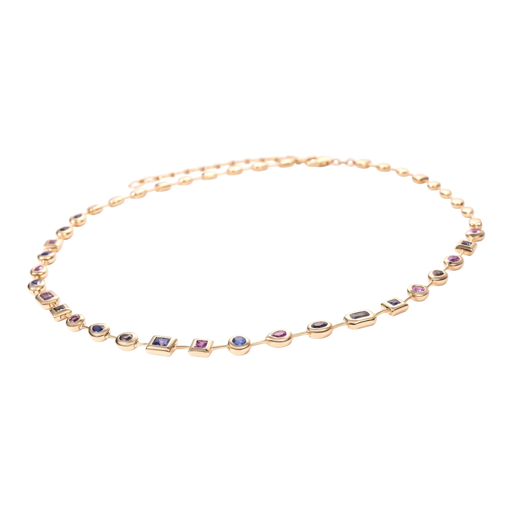 Stunning adjustable 14K yellow gold necklace featuring a unique arrangement of mixed-shaped bezel-set pastel sapphires, adding a light touch of color and elegance to any ensemble. Close up side angle. 