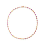 Romantic yellow gold tennis necklace featuring bezel-set oval-shaped pink sapphires and sparkling diamonds, offering a delicate yet luxurious design perfect for special occasions.
