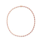 Romantic yellow gold tennis necklace featuring bezel-set oval-shaped pink sapphires and sparkling diamonds, offering a delicate yet luxurious design perfect for special occasions.