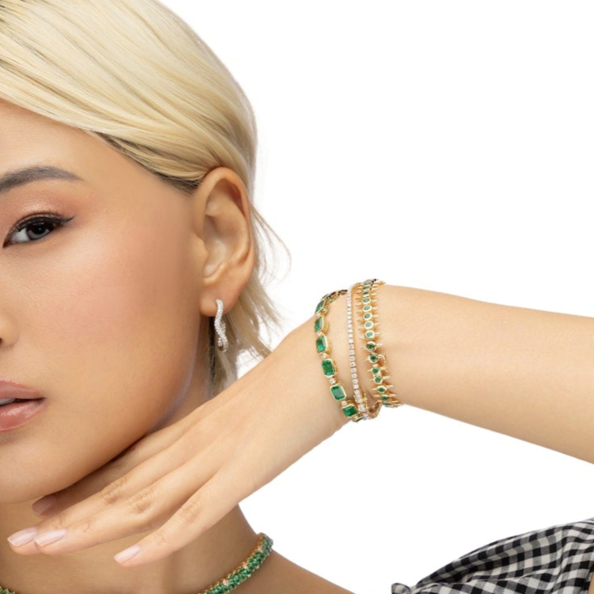 One-of-a-kind 14K yellow gold cocktail tennis bracelet featuring natural  emeralds accented with diamonds. 