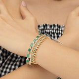 One-of-a-kind 14K yellow gold cocktail tennis bracelet featuring natural  emeralds accented with diamonds. 