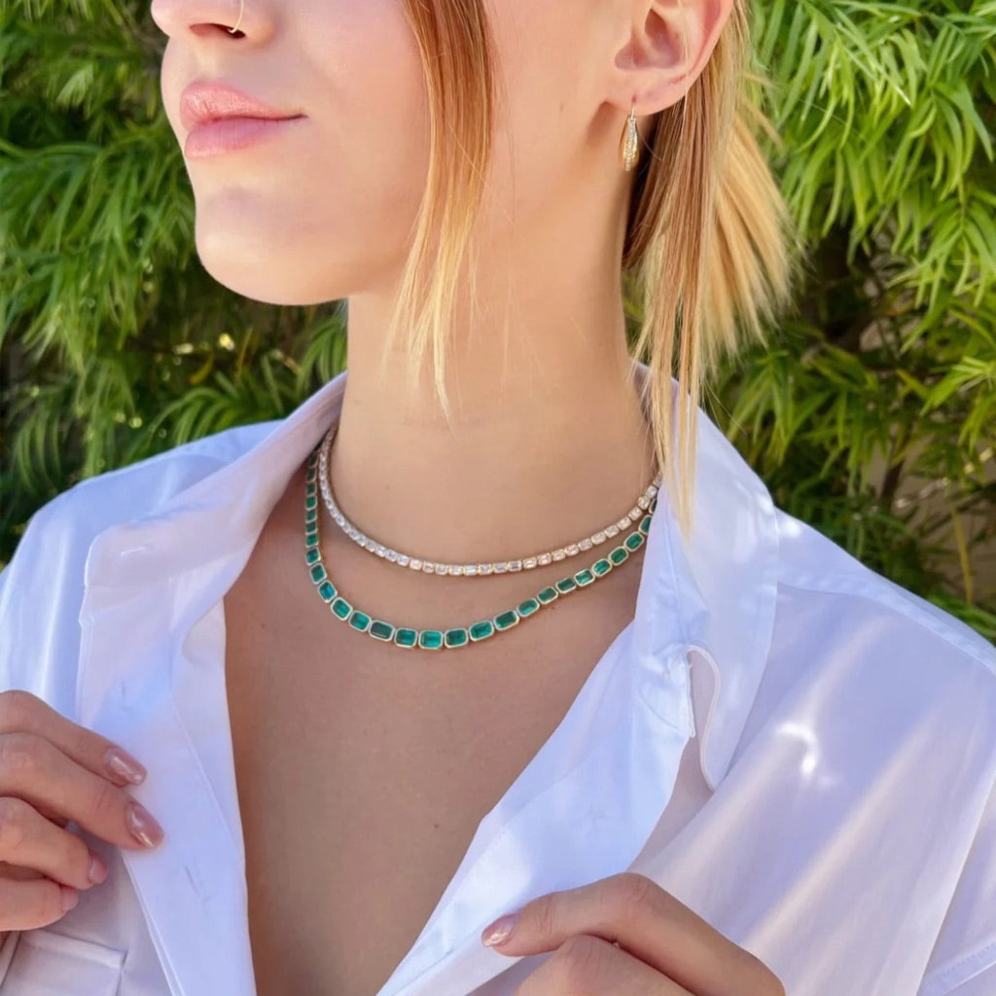 Adjustable 14K yellow gold necklace featuring 38.87 carats of natural, unheated Zambian emeralds in bezel settings, with the largest stone measuring 8.4mm x 6.1mm, offering vibrant green luxury and timeless elegance.