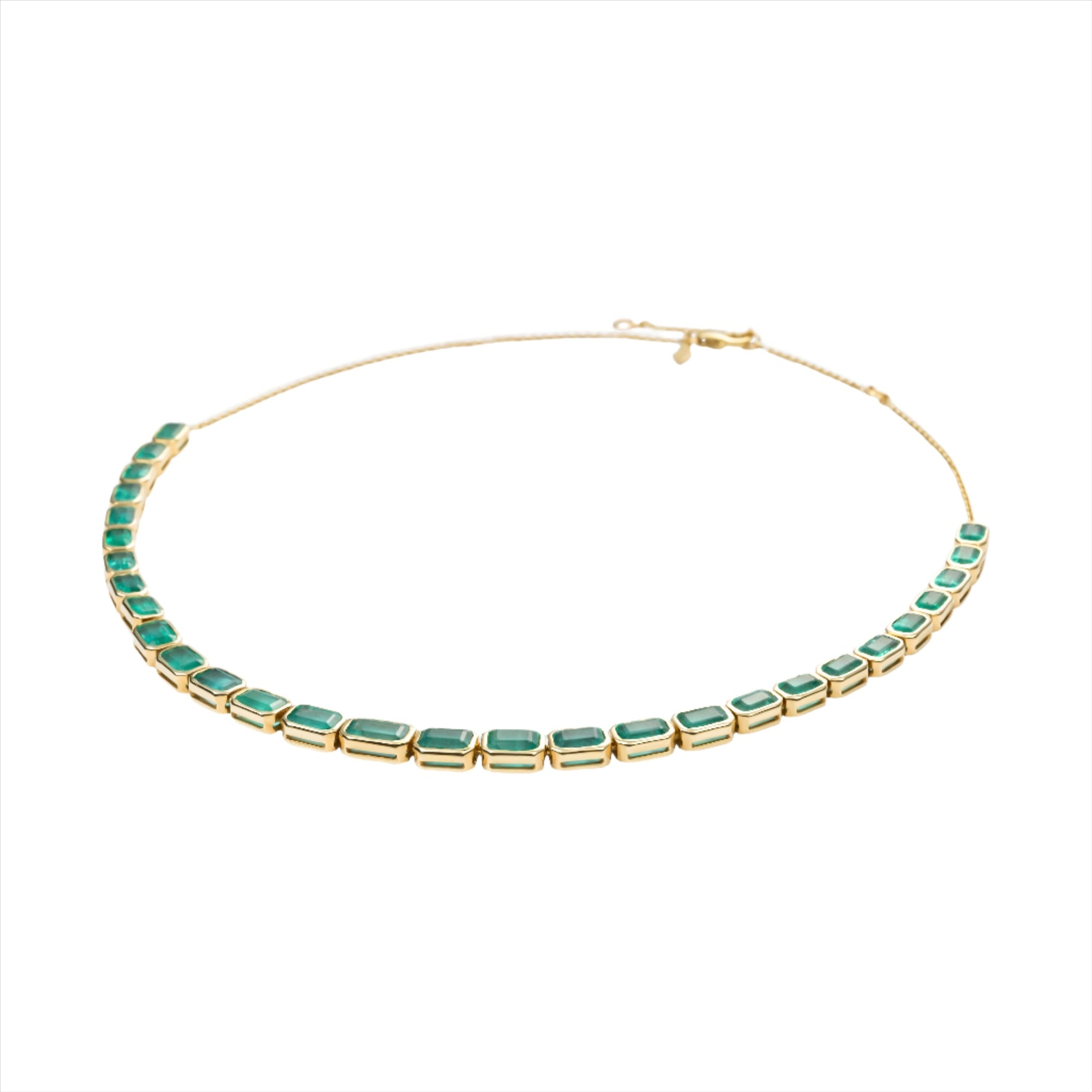 Adjustable 14K yellow gold necklace featuring 38.87 carats of natural, unheated Zambian emeralds in bezel settings, with the largest stone measuring 8.4mm x 6.1mm, offering vibrant green luxury and timeless elegance.
