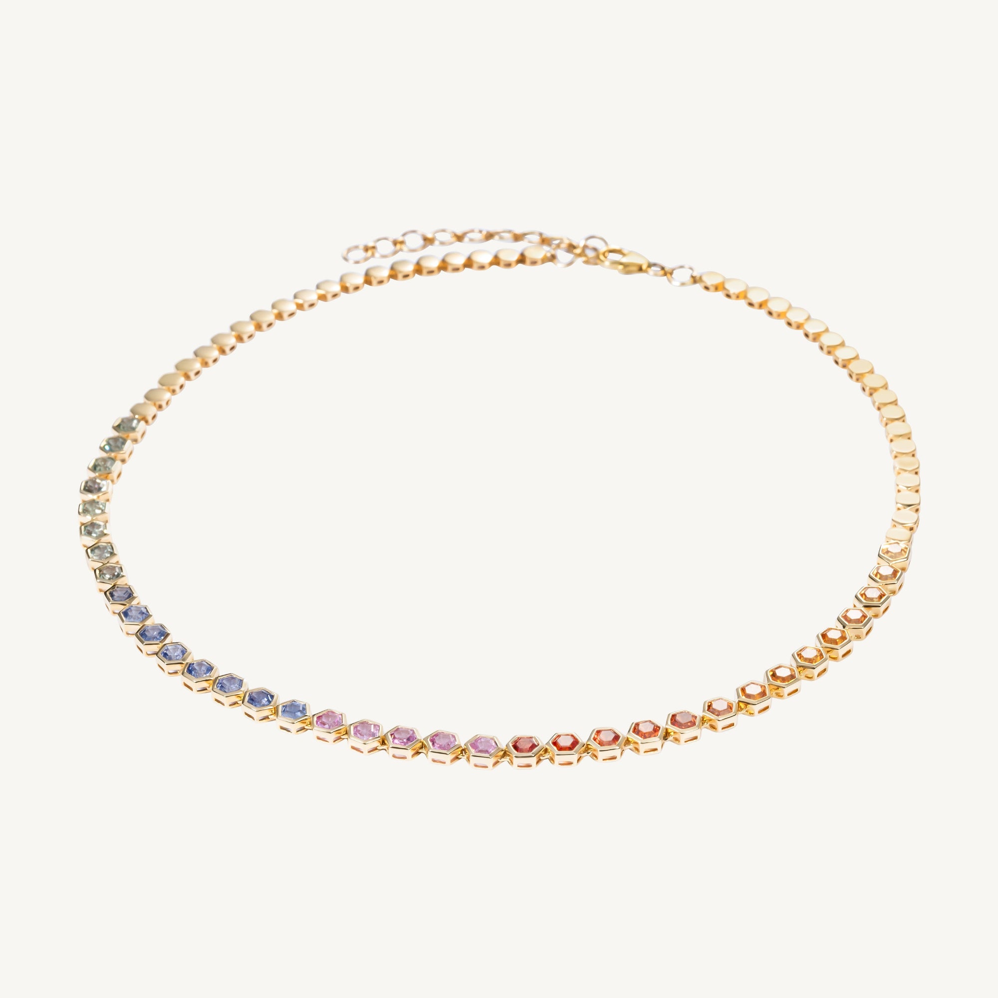 Exquisite 14K yellow gold necklace featuring 11.50ct of bezel-set multicolored hexagon-cut sapphires, finished with gold beads and an adjustable 16–18 inch length for a truly unique, forever piece.