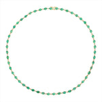  Elegant 14K yellow gold tennis necklace featuring 15.43ct of bezel-set oval-shaped Colombian emeralds and 0.93ct of sparkling solitaire diamonds, with a 17-inch length—a timeless and sophisticated gemstone statement.