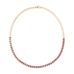 Luxurious 14K yellow gold tennis necklace featuring 10.14ct of bezel-set emerald cut pink sapphires, 16 inches in length and weighing 25.74g—a refined and radiant statement piece.