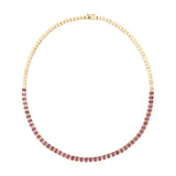 Luxurious 14K yellow gold tennis necklace featuring 10.14ct of bezel-set emerald cut pink sapphires, 16 inches in length and weighing 25.74g—a refined and radiant statement piece.