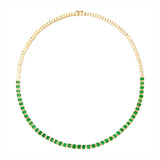Luxurious 14K yellow gold tennis necklace featuring 23.59ct of beautifully matched emerald-cut Tsavorite garnets in a bold bezel setting, with a 16-inch length and total weight of 24.56g.