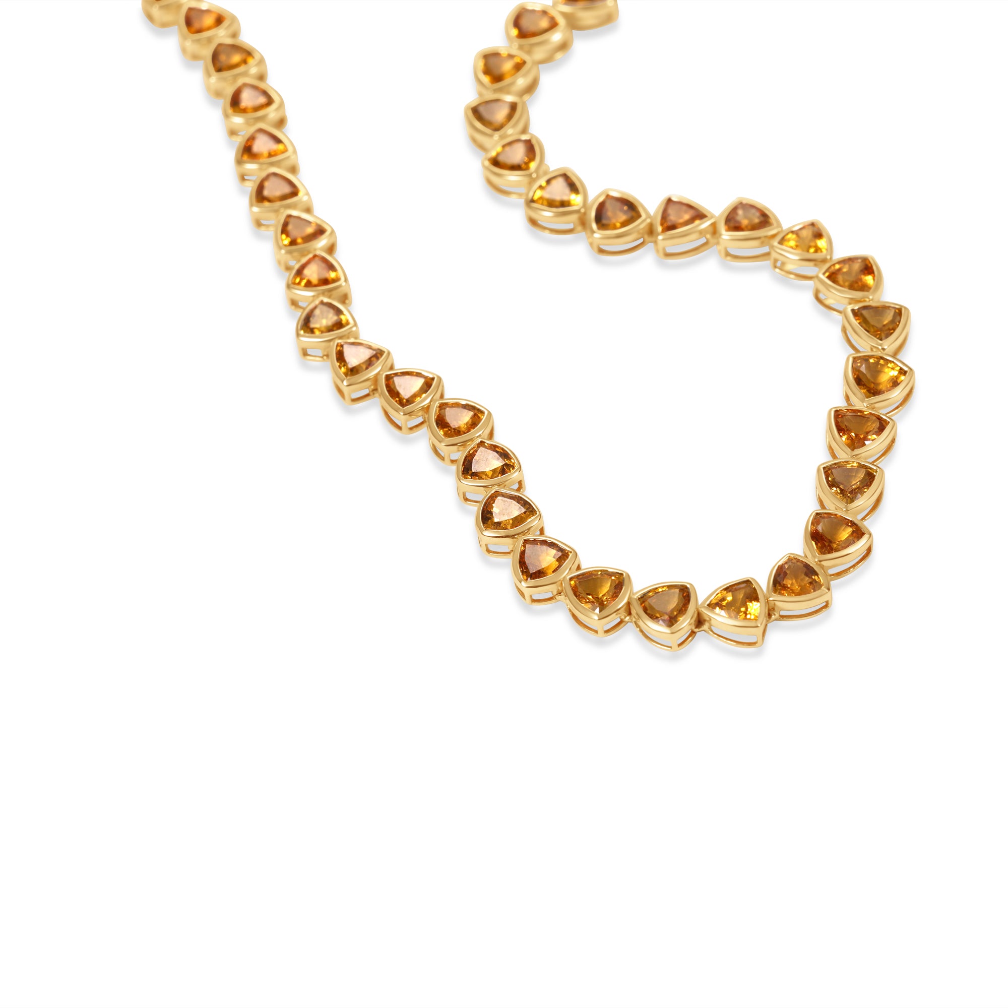 Elegant 14K gold tennis necklace featuring vibrant bezel-set and trillion-cut goldenrod orange sapphires, offering a modern twist on a timeless design with luxurious flair. Close up 