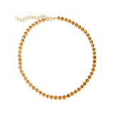 Elegant 14K gold tennis necklace featuring vibrant bezel-set and trillion-cut goldenrod orange sapphires, offering a modern twist on a timeless design with luxurious flair.