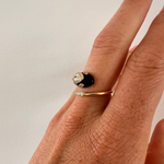 Captivating serpent ring crafted from 14K yellow gold and black enamel, featuring 0.35ct of G-H VS diamonds—an exotic and bold statement piece with luxurious edge. On finger.