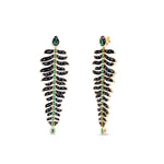 One-of-a-kind 14K yellow gold feather earrings featuring black onyx, emeralds, and diamonds, uniquely designed for versatility—wear as dramatic dangle earrings or convert into a striking feather bracelet paired with emerald studs. Shown close up as earrings.