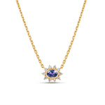 Exquisite anemone flower necklace featuring a stunning oval-cut blue sapphire at the center, surrounded by ten pear-shaped diamonds in a captivating floral design, crafted in elegant gold. Close up of front view. 
