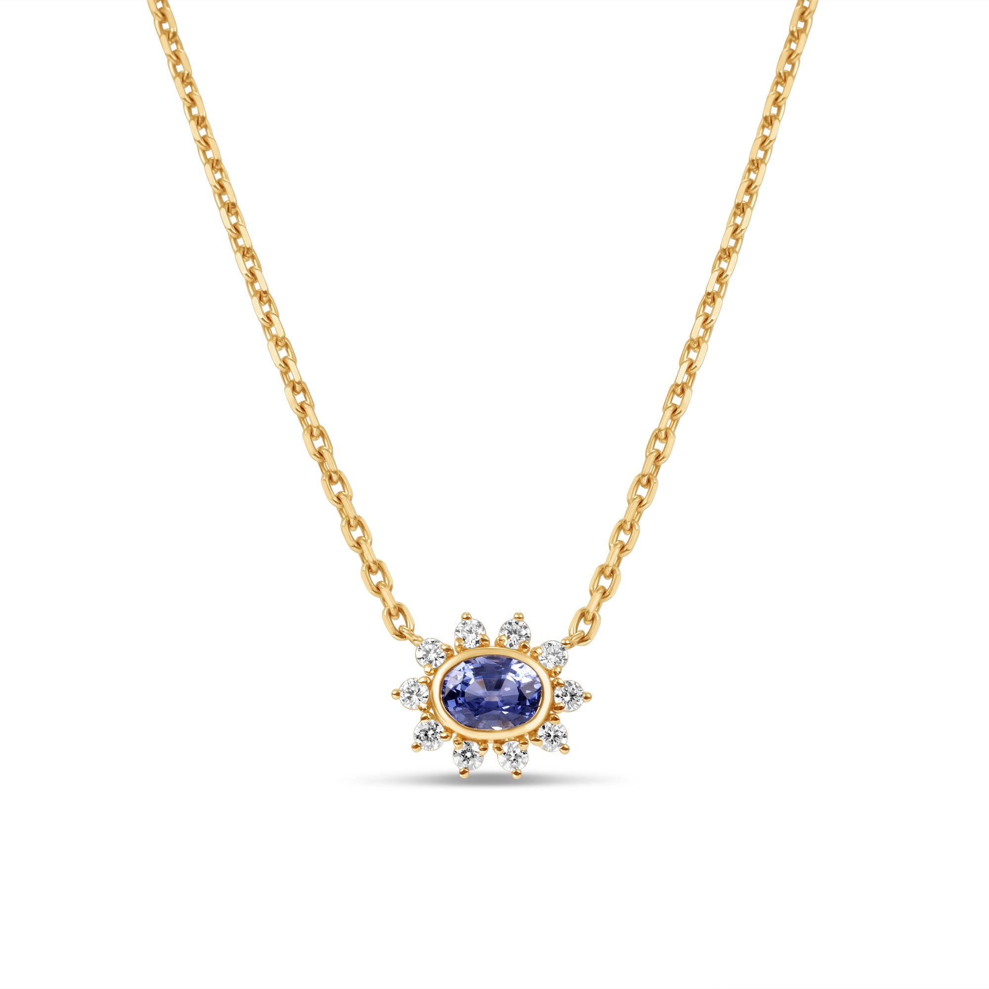 Exquisite anemone flower necklace featuring a stunning oval-cut blue sapphire at the center, surrounded by ten pear-shaped diamonds in a captivating floral design, crafted in elegant gold. Close up of front view. 