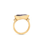 Elegant 18K yellow gold kite ring featuring a mesmerizing blue sapphire, accented by two bezel-set diamonds, merging bold geometry with timeless sophistication. Side view detailing of band.