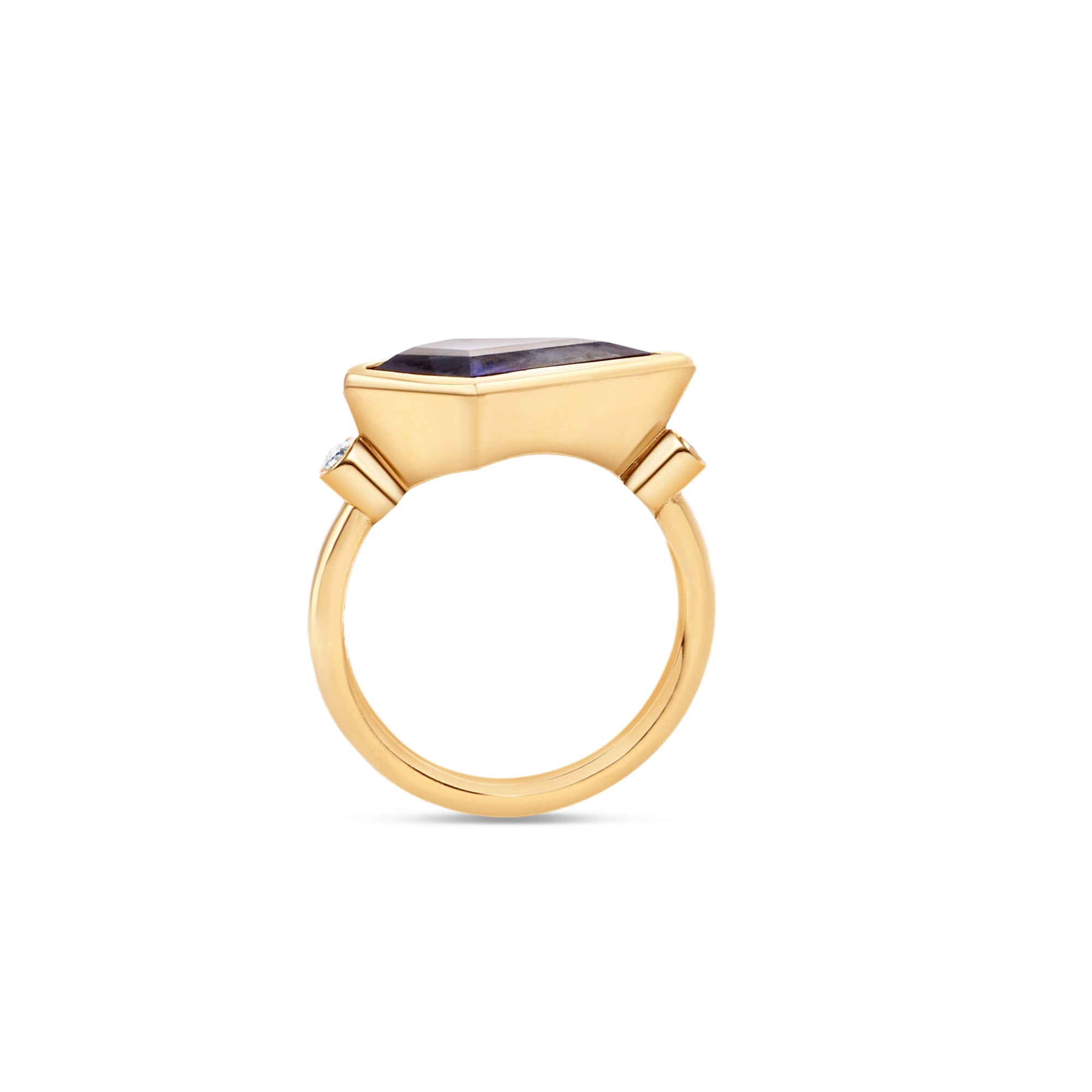 Elegant 18K yellow gold kite ring featuring a mesmerizing blue sapphire, accented by two bezel-set diamonds, merging bold geometry with timeless sophistication. Side view detailing of band.