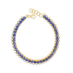 Elegant 14K yellow gold line bracelet featuring vibrant blue sapphires beautifully offset by shimmering diamonds, offering a timeless design that blends versatility with refined luxury. Top down view
