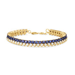 Elegant 14K yellow gold line bracelet featuring vibrant blue sapphires beautifully offset by shimmering diamonds, offering a timeless design that blends versatility with refined luxury. Front View 