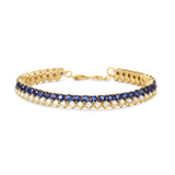 Elegant 14K yellow gold line bracelet featuring vibrant blue sapphires beautifully offset by shimmering diamonds, offering a timeless design that blends versatility with refined luxury. Front View 