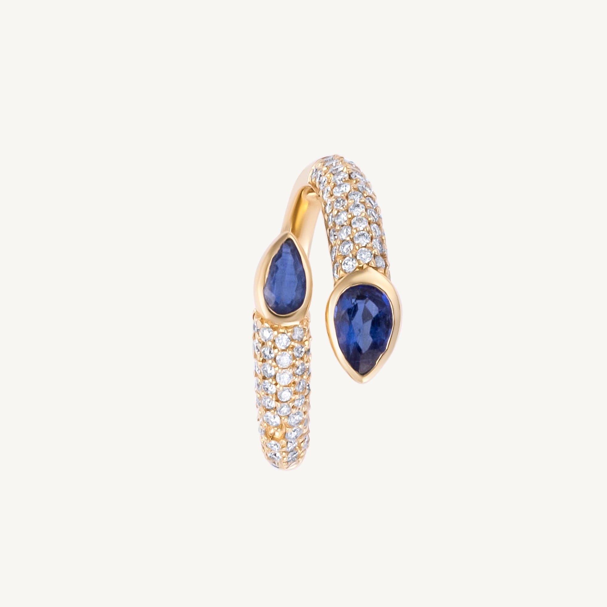 Elegant 14K yellow gold serpent-style bypass ring featuring two bezel-set pear-cut blue sapphires (0.735ct) and 0.482ct of G-H VS pavé diamonds, offering a bold and refined silhouette.