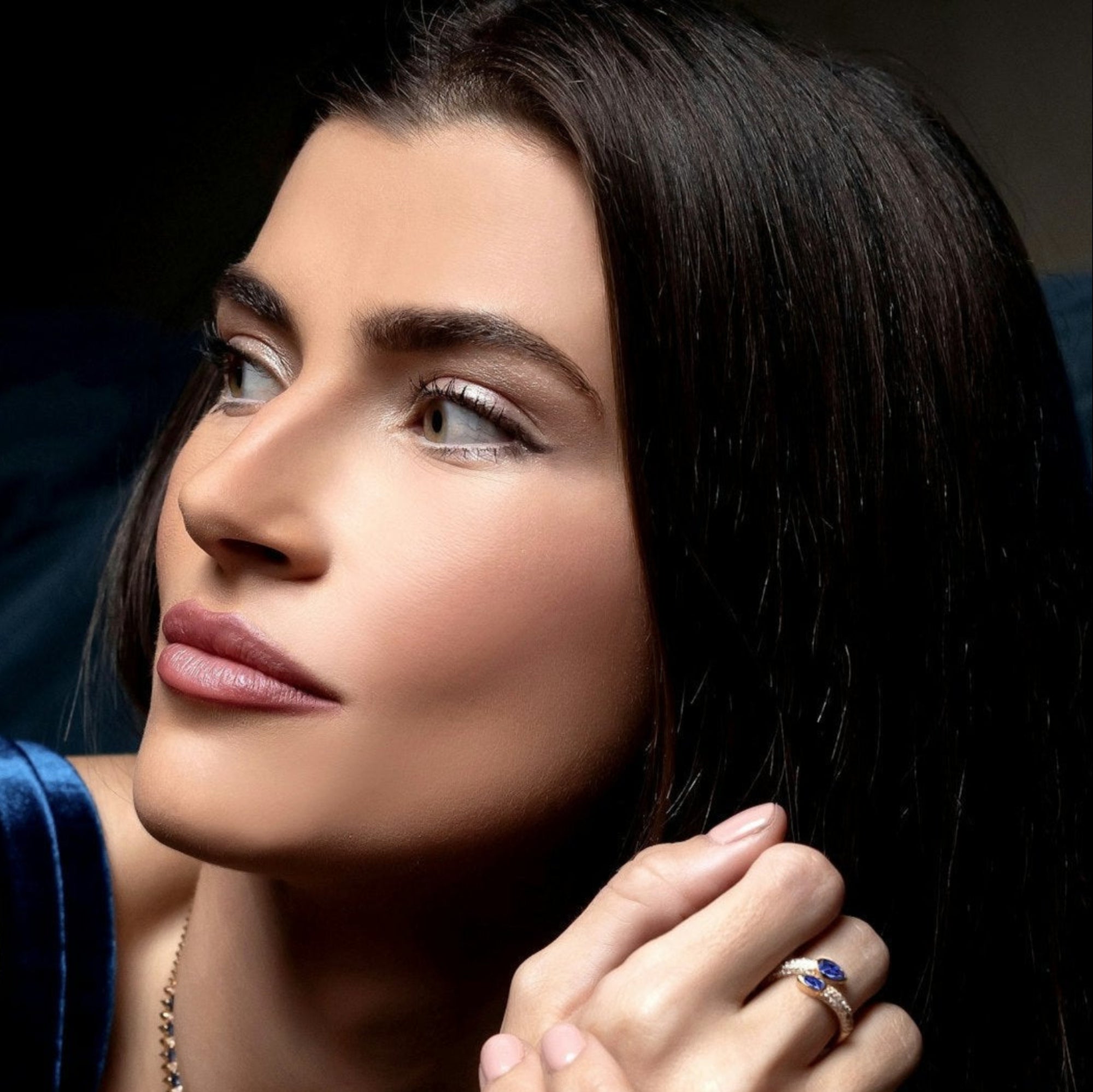 Elegant 14K yellow gold serpent-style bypass ring featuring two bezel-set pear-cut blue sapphires (0.735ct) and 0.482ct of G-H VS pavé diamonds, offering a bold and refined silhouette.