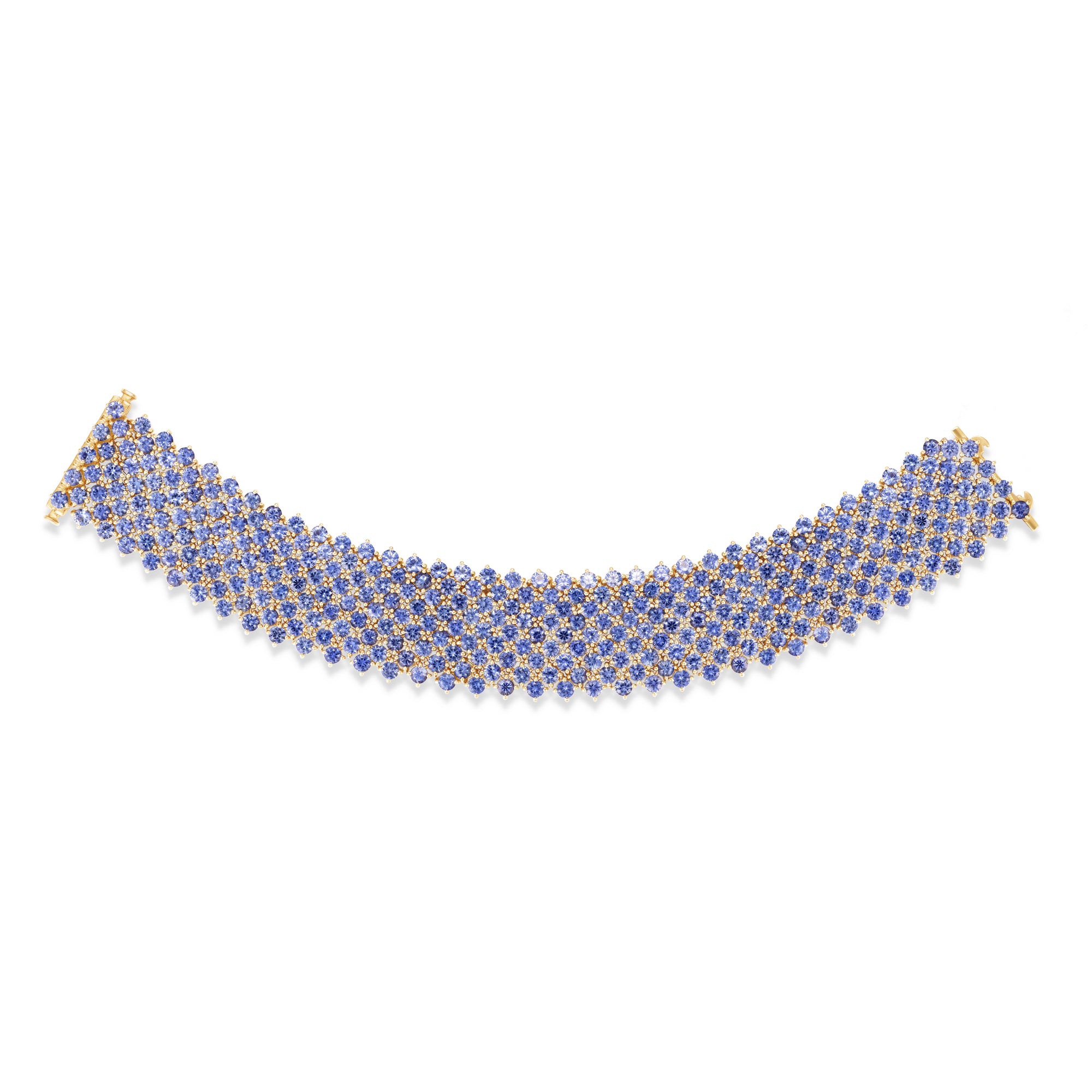 Masterfully crafted 14K yellow gold flexible woven cuff bracelet featuring vibrant cornflower blue sapphires, offering a radiant and timeless statement of Italian elegance. Flat lay.