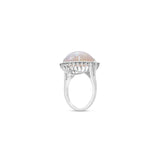  18K white gold ring features a mesmerizing cabochon white opal, beautifully framed by a halo of modified prong-set diamonds Side facing