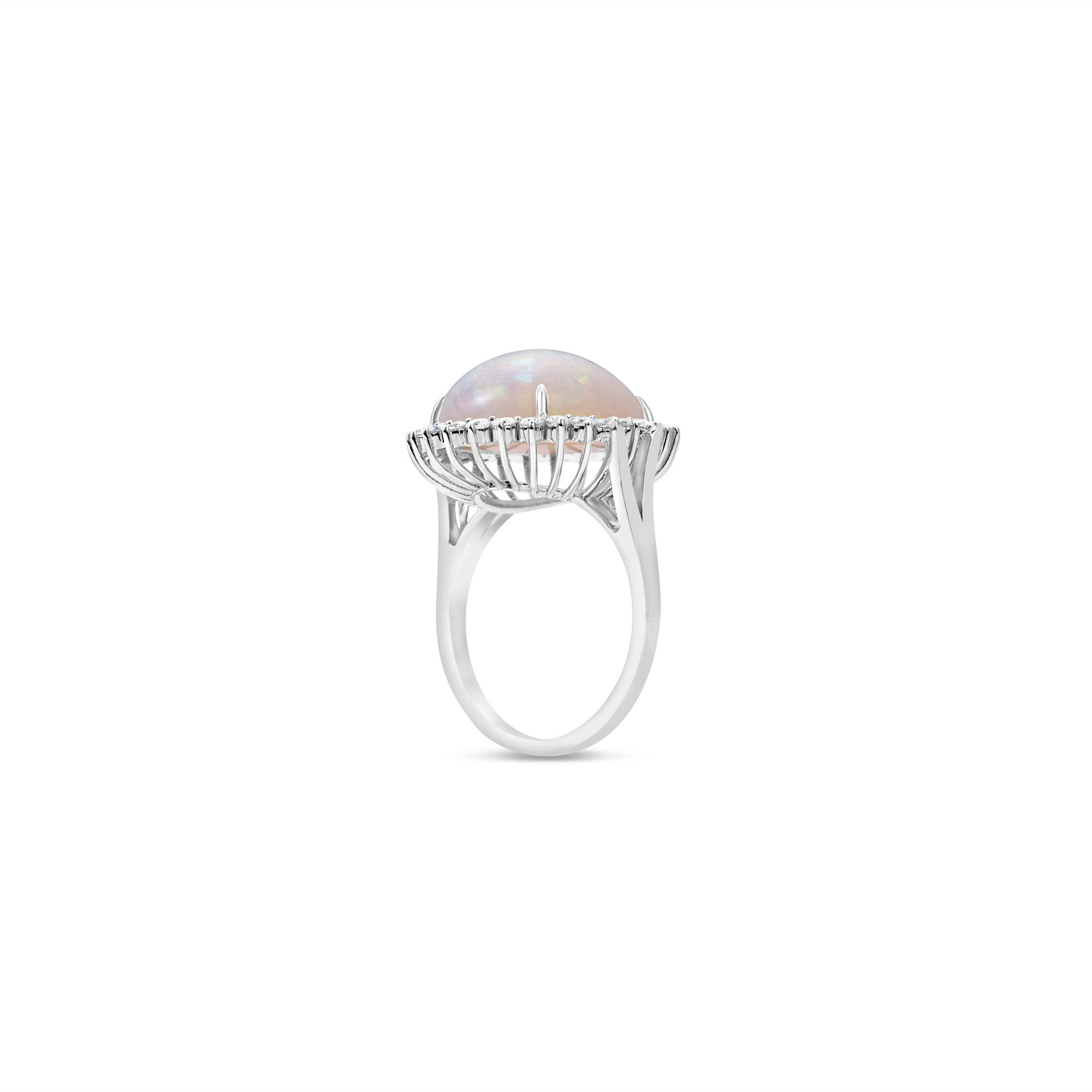  18K white gold ring features a mesmerizing cabochon white opal, beautifully framed by a halo of modified prong-set diamonds Side facing