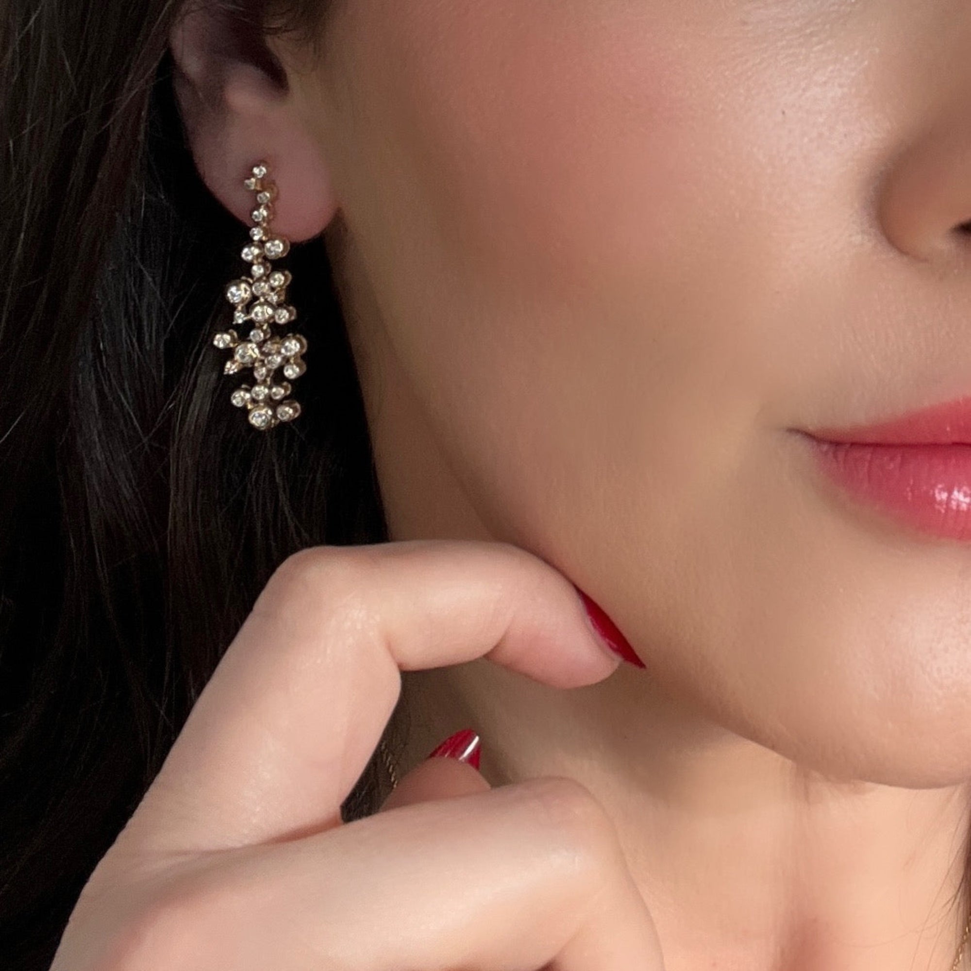 Elegant 14K yellow gold earrings featuring a cascading constellation-inspired spray of diamonds totaling 1.02ct, with articulated tiers flowing to 1.5 inches in length and 0.5 inches at the widest point.
