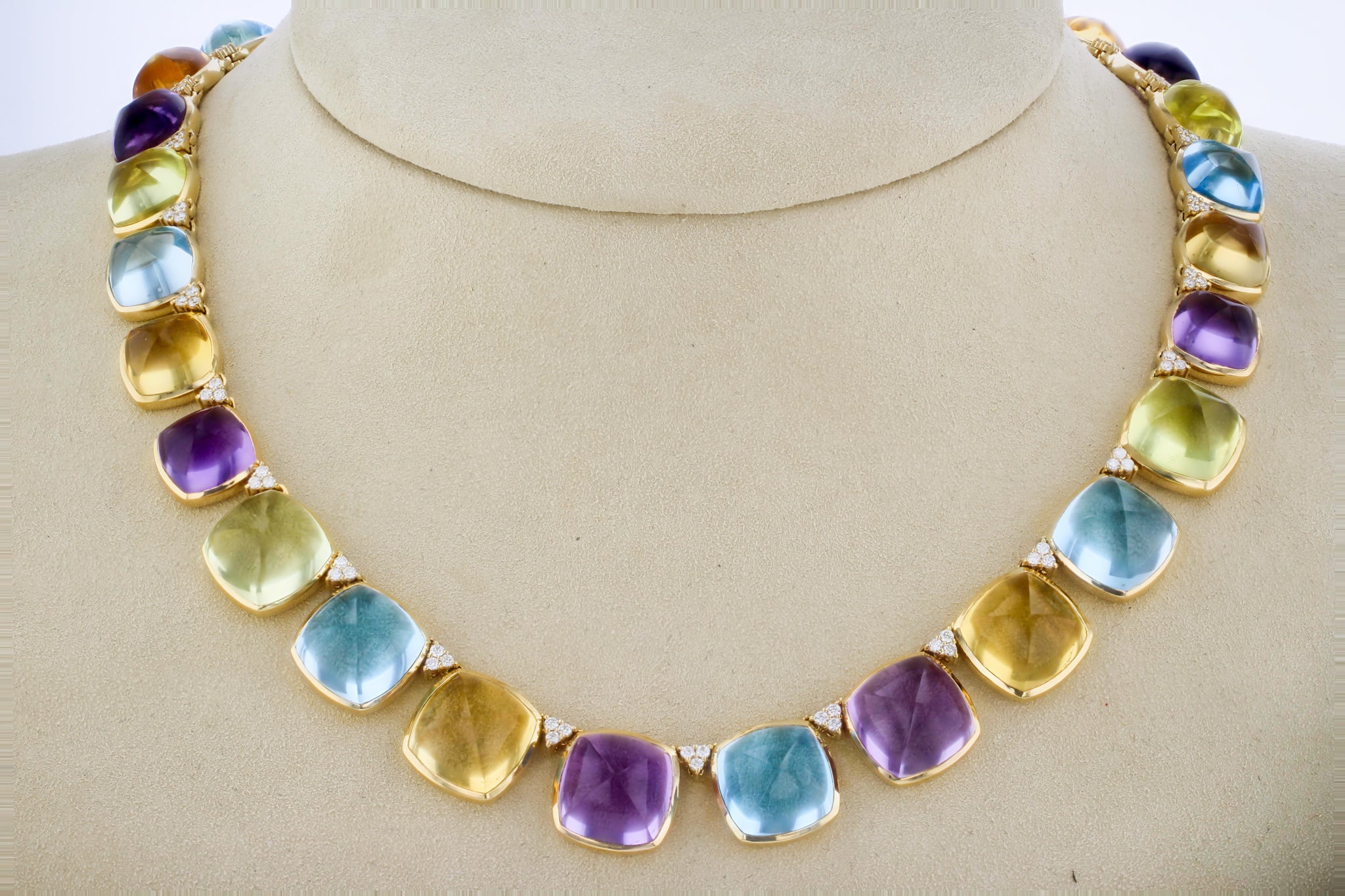 This stunning sugarloaf-cut gemstone necklace, featuring vibrant citrine, amethyst, and topaz, is expertly handcrafted in a luxurious design, blending playful charm with sophisticated elegance. Close Up