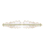 One-of-a-kind 14K yellow gold feather earrings featuring clear rock quartz, emeralds, and sparkling diamonds, designed for versatility—wear them as statement dangle earrings or transform the detachable feathers into a unique bracelet complemented by emerald stud earrings. Shown as bracelet. 