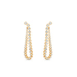 Meticulously crafted 14K yellow gold convertible earrings featuring round bezel-set diamonds in a loop design, offering versatility to be worn as classic loop earrings or sleek linear drop earrings for any occasion. Closed into loop. 
