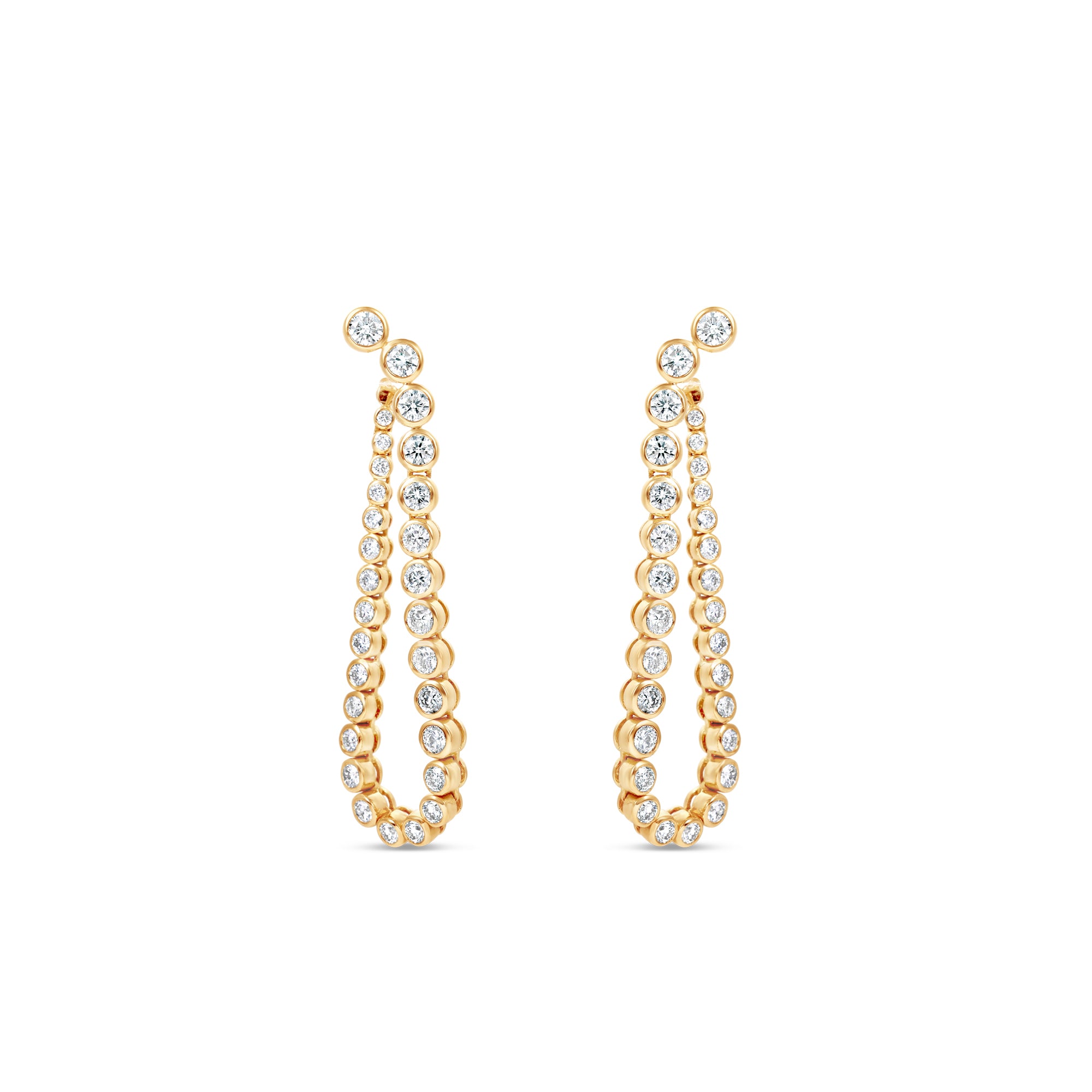 Meticulously crafted 14K yellow gold convertible earrings featuring round bezel-set diamonds in a loop design, offering versatility to be worn as classic loop earrings or sleek linear drop earrings for any occasion. Closed into loop. 