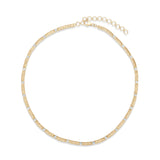 Graceful 14K yellow gold slinky necklace featuring delicately set diamond accents, offering understated luxury with a smooth, flowing design—perfect for layering or wearing alone.